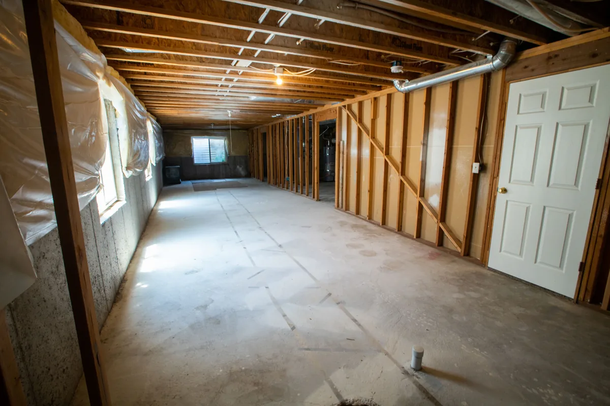 A remodeled Florida lower level with flood-resistant flooring and a dry, mold-free finished wall