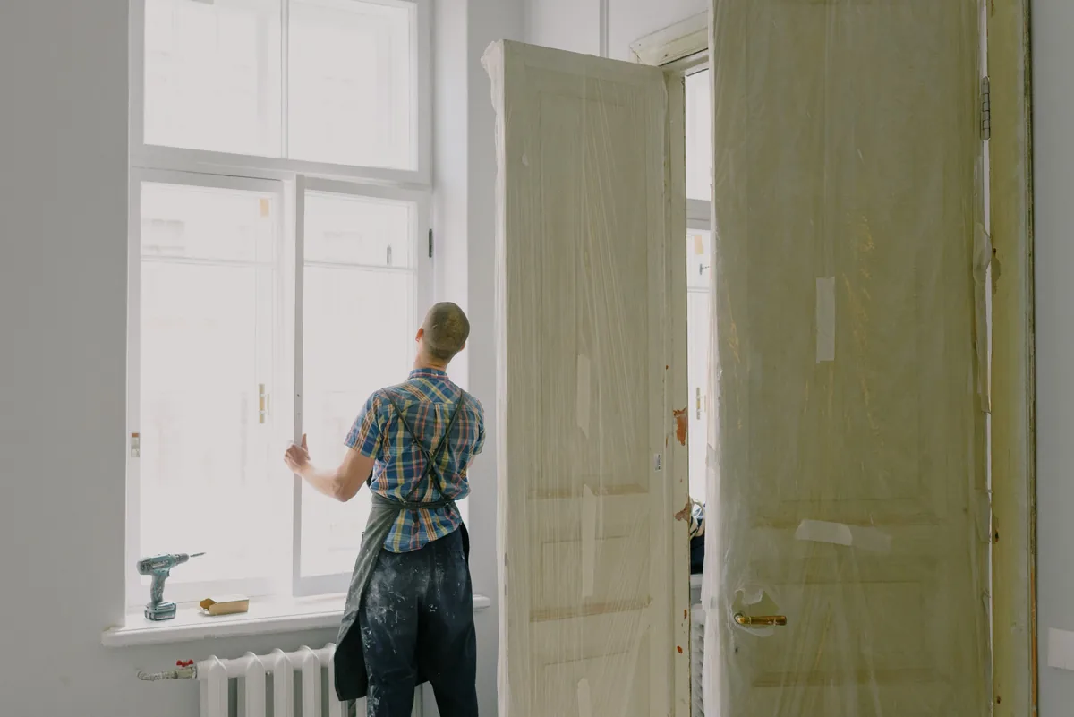 Installer tooling mildew-resistant silicone on the wet side of a Florida frameless shower door
