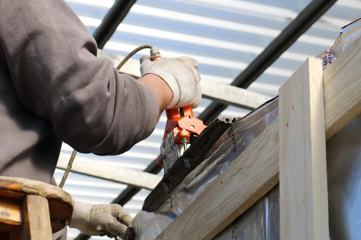 Installer anchoring a closet system to a Florida concrete block wall with masonry fasteners