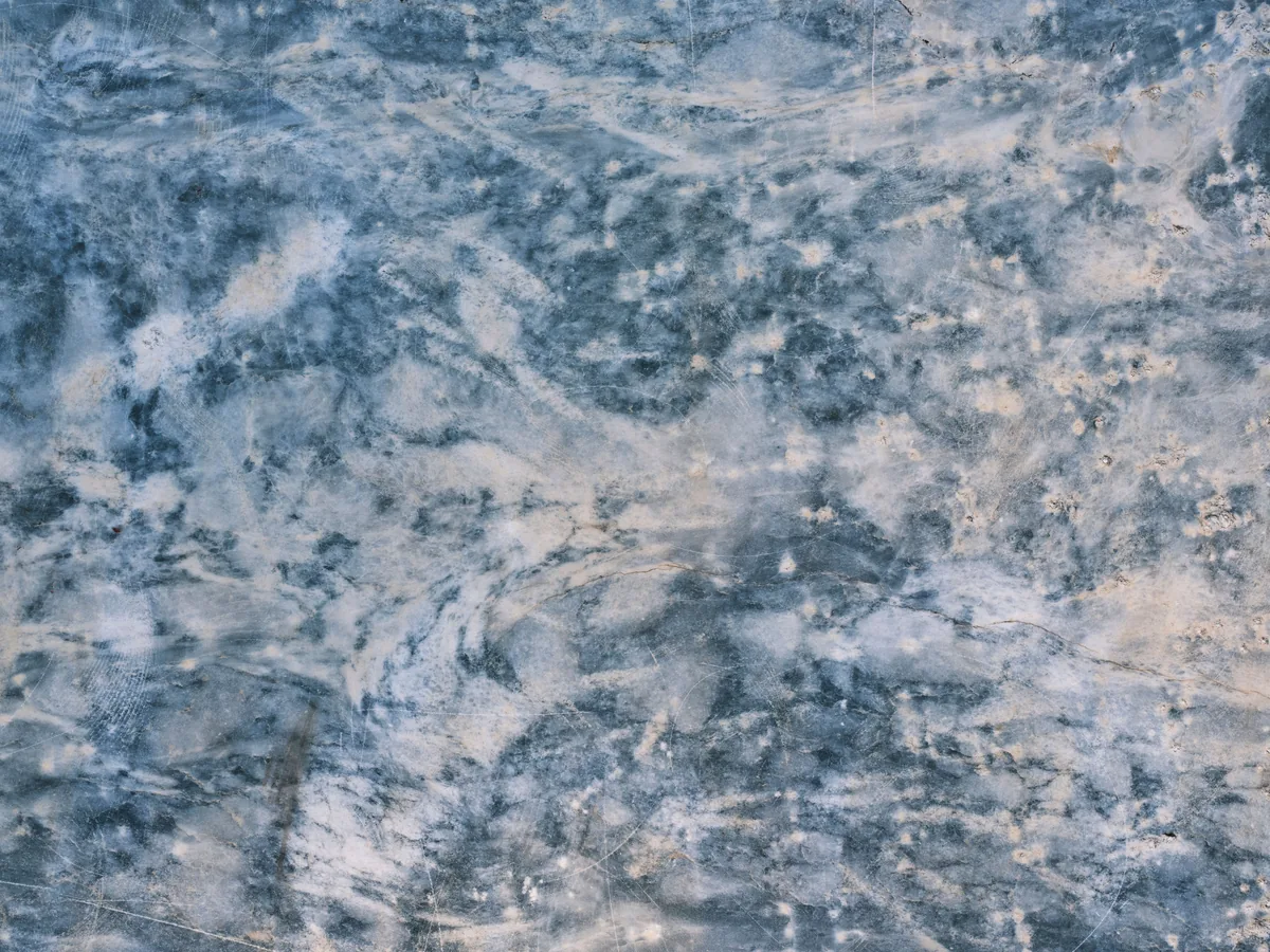 Close-up of a polished natural granite slab showing unique veining and a polished edge profile