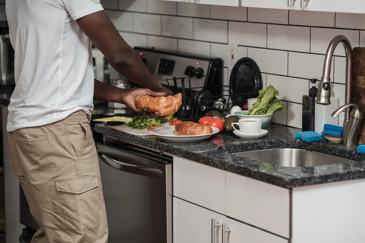 Installer applying sealant to a granite countertop after setting it in a Florida kitchen