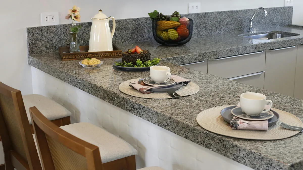 Florida kitchen with a quartz perimeter and a contrasting natural stone island countertop