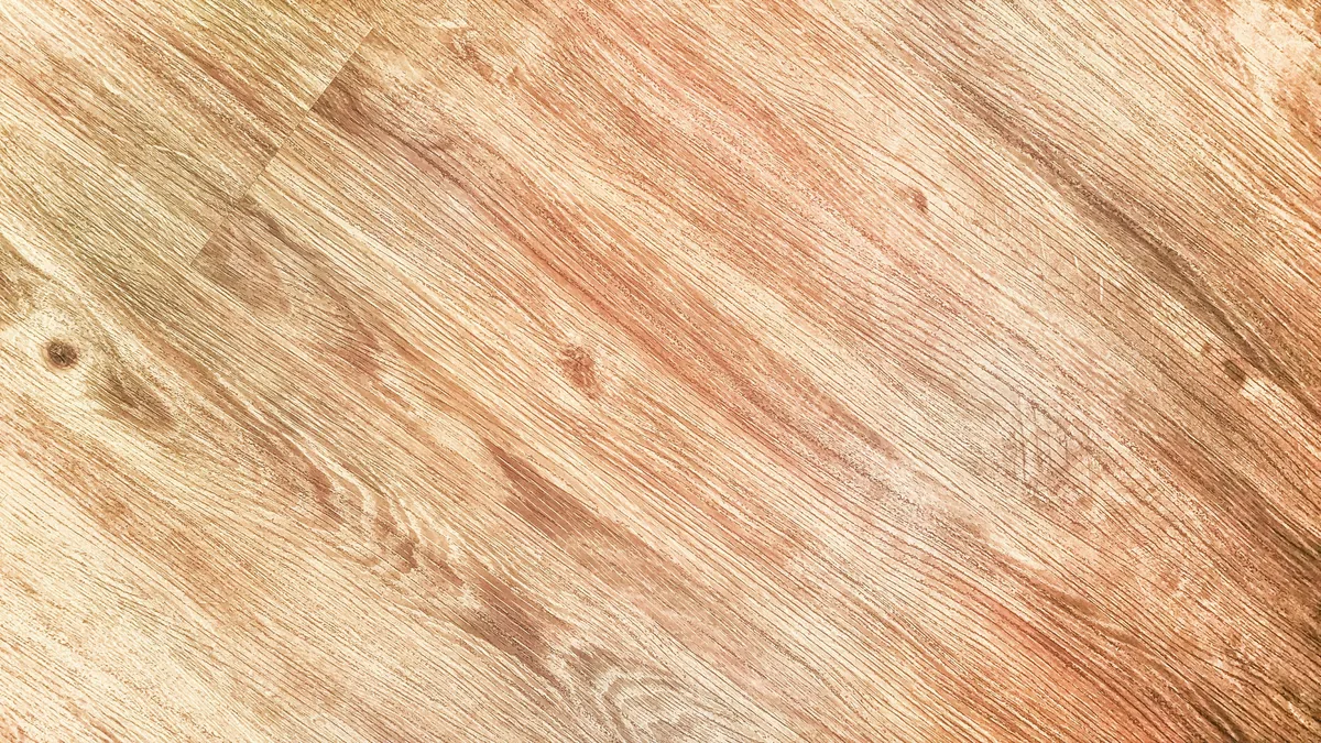 Cross-section of rigid-core luxury vinyl plank showing wear layer, design film, and SPC core