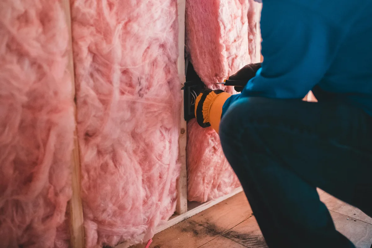 Programmable floor-sensing thermostat for radiant heat mounted on a Florida bathroom wall