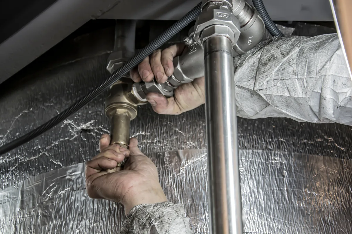 Installer measuring the rise and run of a Florida staircase against code requirements