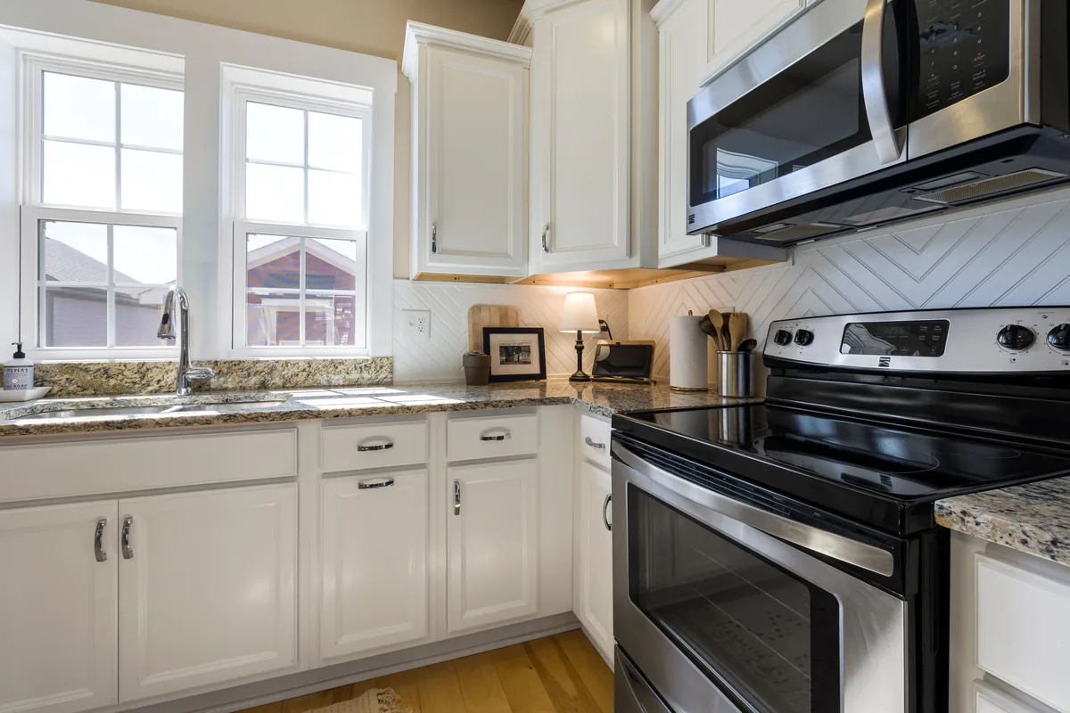 Newly remodeled Florida kitchen with plywood-box cabinets, quartz counters, sealed-grout backsplash, and waterproof flooring