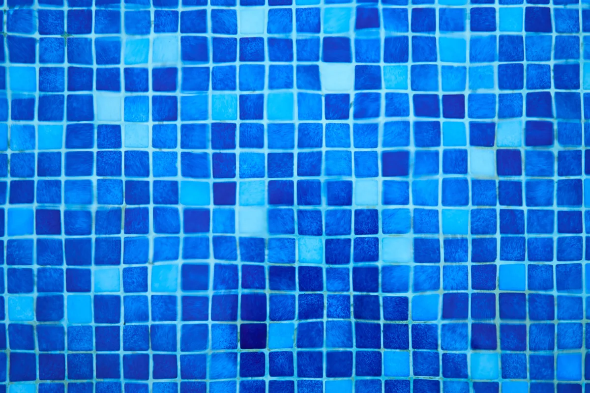 Florida kitchen backsplash of glass and ceramic tile with sealed grout set behind the counter and cooktop