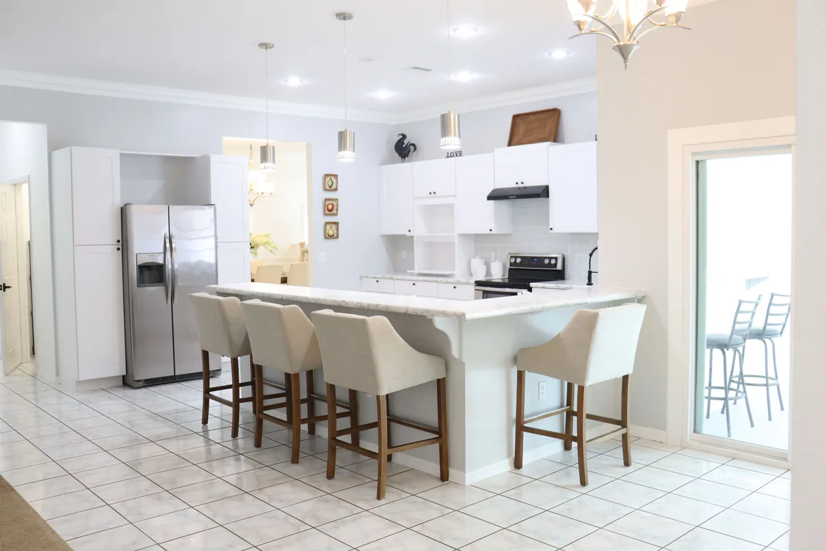 Engineered beam set across a new opening between a Florida kitchen and living room during an open-concept conversion