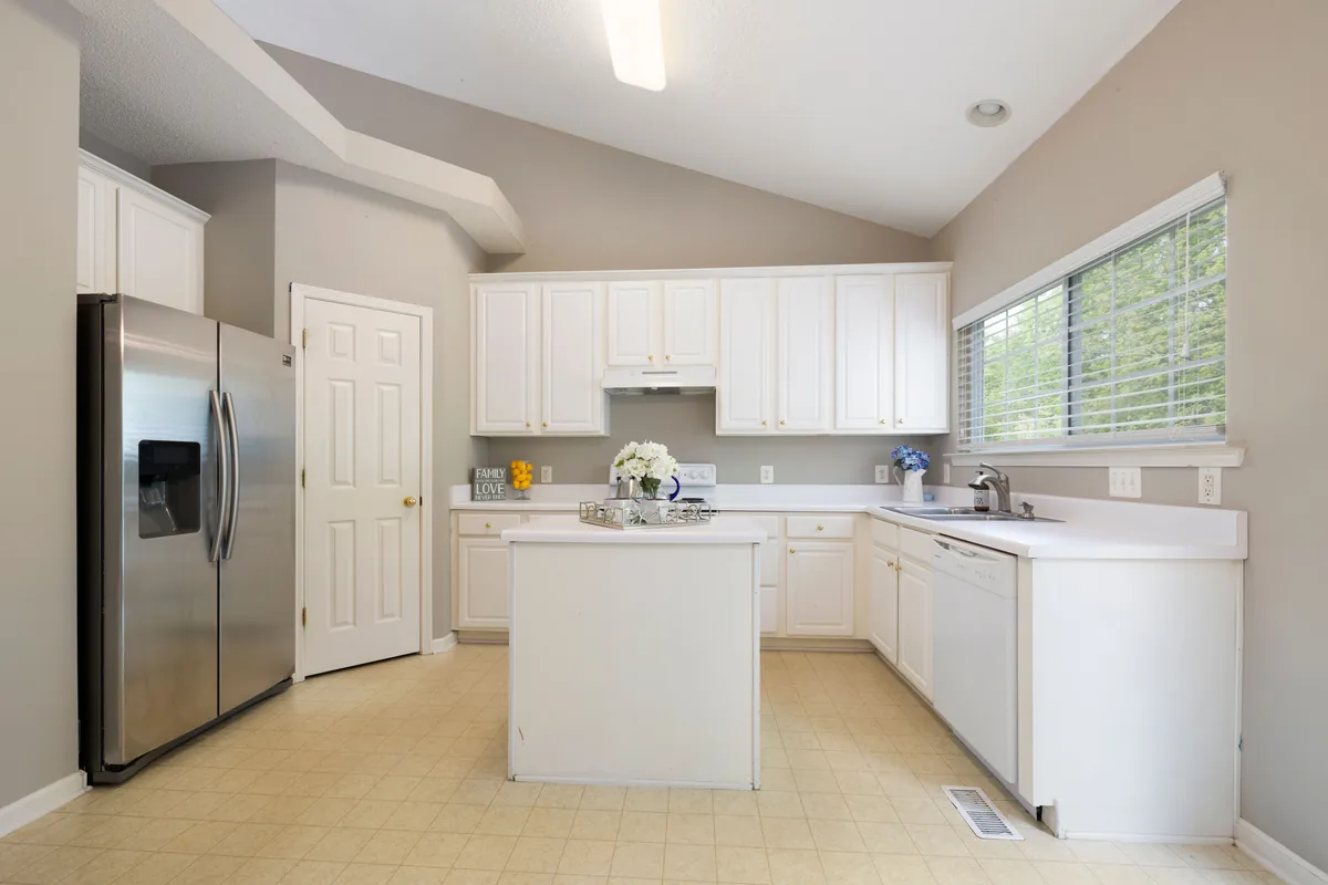 Open-concept Florida kitchen and living room with continuous waterproof flooring and rebalanced HVAC after a wall removal