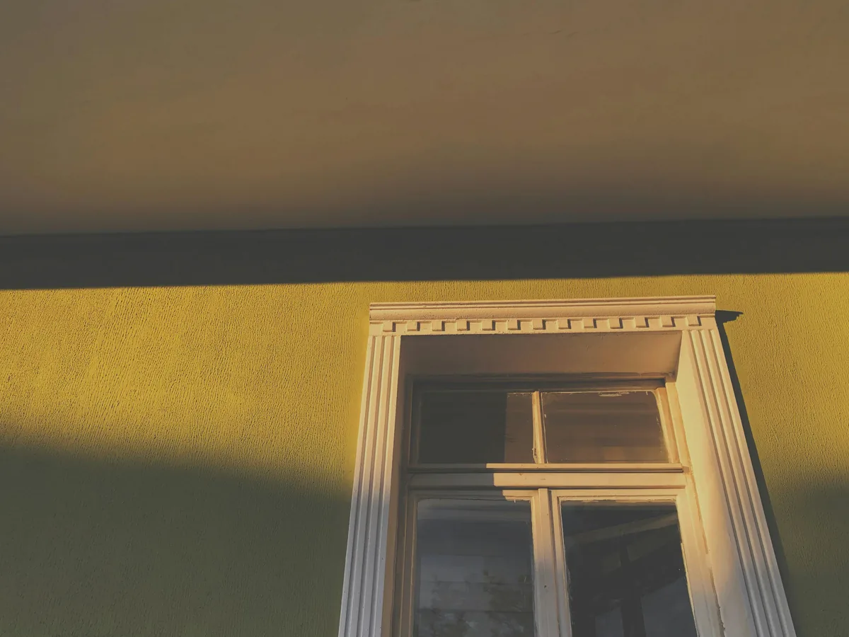 Lightweight polyurethane crown molding profile being dry-fit at a Florida ceiling line