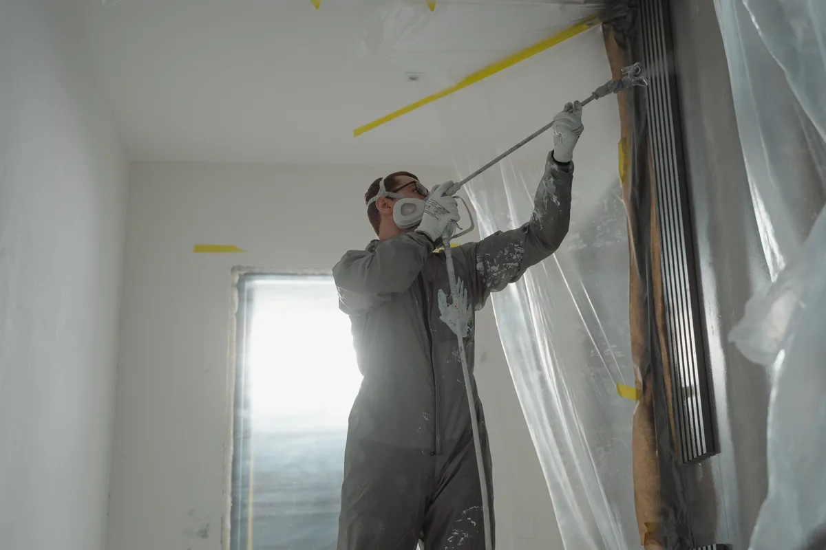 Installer knocking down sprayed texture on a Florida wall patch to match the surrounding finish